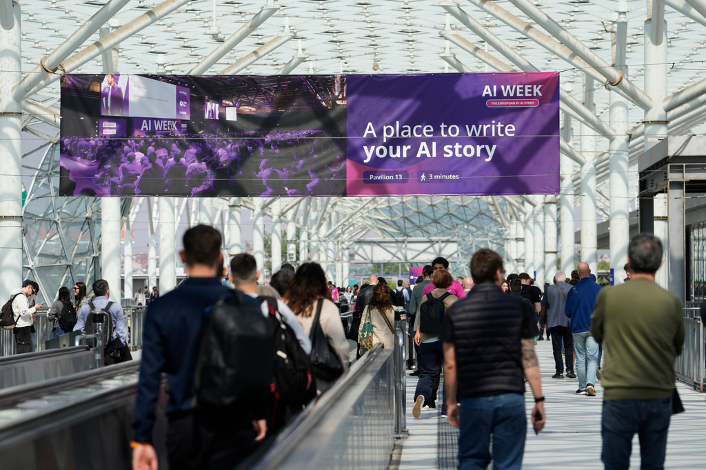Visitors arrive to the Europe largest artificial intelligence event, AI Week 2026, in Rho, near Milan, Italy, Tuesday, May 19, 2026. (AP Photo/Luca Bruno)