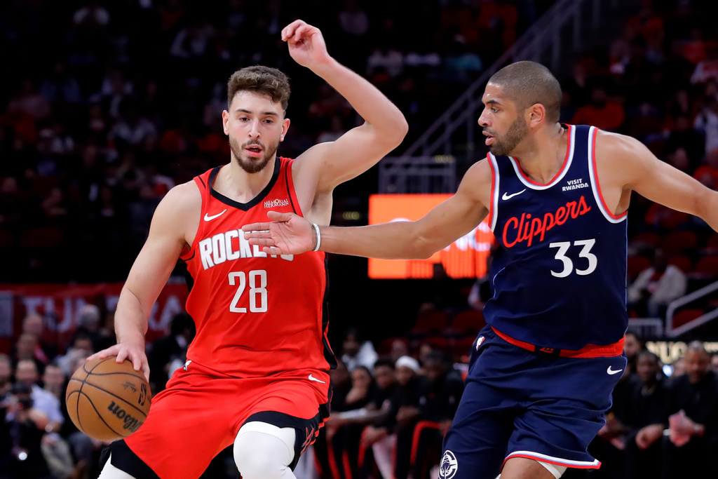 Houston Rockets center Alperen Sengun (28) attempts to drive around LA Clippers forward Nicolas Batum (33) during the first half of an NBA basketball game Thursday, Dec. 11, 2025, in Houston. (AP Photo/Michael Wyke)