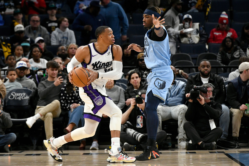Sacramento Kings guard Russell Westbrook, left, handles the ball against Memphis Grizzlies guard Jahmai Mashack, right, in the first half of an NBA basketball game Monday, Feb. 23, 2026, in Memphis, Tenn. (AP Photo/Brandon Dill)