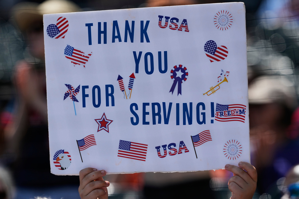 A baseball fan holds up a sign for Memorial Day before a baseball game between the Minnesota Twins and the Chicago White Sox in Chicago, Monday, May 25, 2026. (AP Photo/Nam Y. Huh)