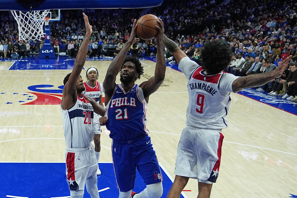 Philadelphia 76ers' Joel Embiid (21) Washington Wizards' Alex Sarr (20) and Justin Champagnie (9) during the first half of an NBA basketball game Wednesday, Jan. 7, 2026, in Philadelphia. (AP Photo/Matt Rourke)