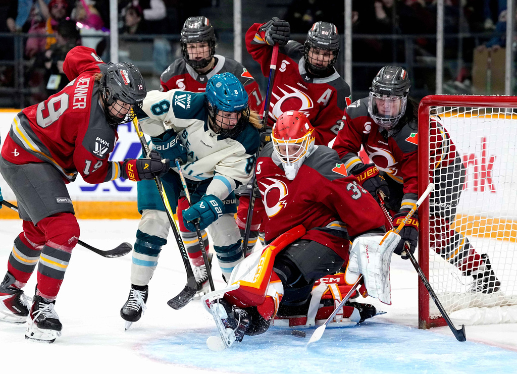 Ottawa Charge goaltender Gwyneth Philips (33) makes the save as Seattle Torrent's Natalie Snodgrass (8) looks for the puck during second period PWHL hockey action in Ottawa, on Wednesday, April 8, 2026. (Justin Tang/The Canadian Press via AP)