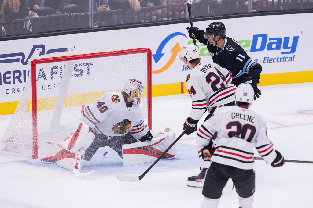 Utah Mammoth right wing Dylan Guenther (11) scores against Chicago Blackhawks goalie Arvid Soderblom (40) during the second period of an NHL hockey game Thursday, Oct. 1, 2026, in Salt Lake City. (AP Photo/Melissa Majchrzak)