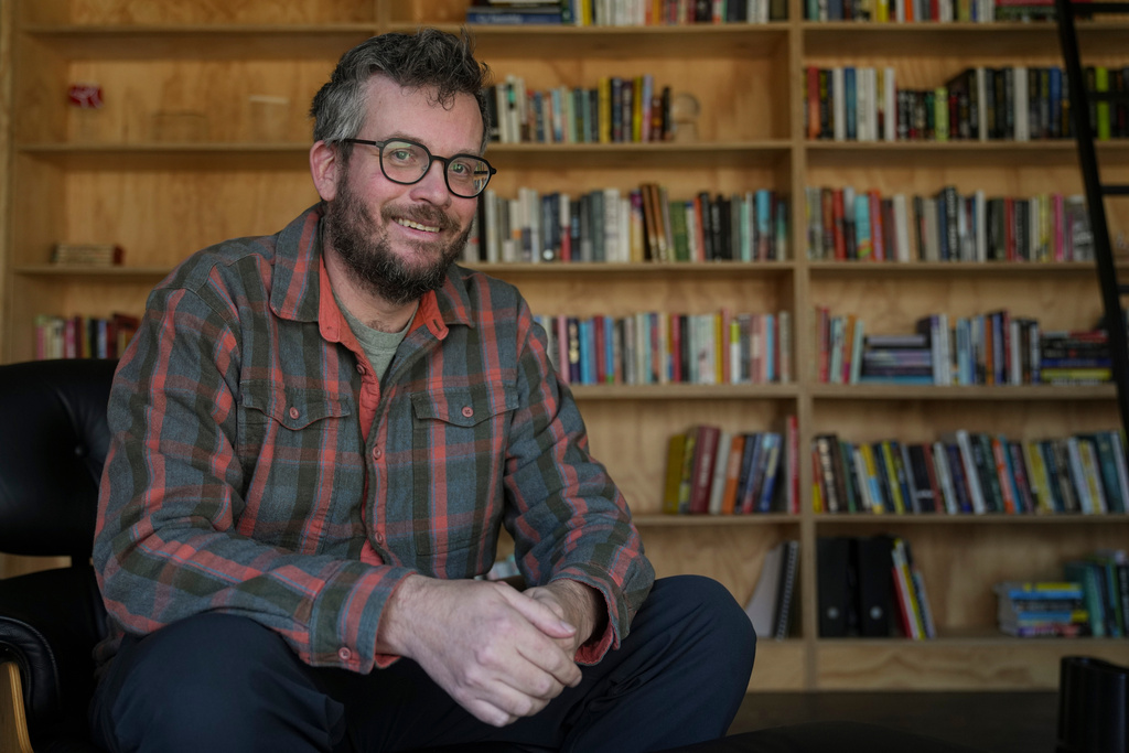 Writer John Green poses in his studio in Indianapolis, Wednesday, Jan. 21, 2026. (AP Photo/Michael Conroy)
