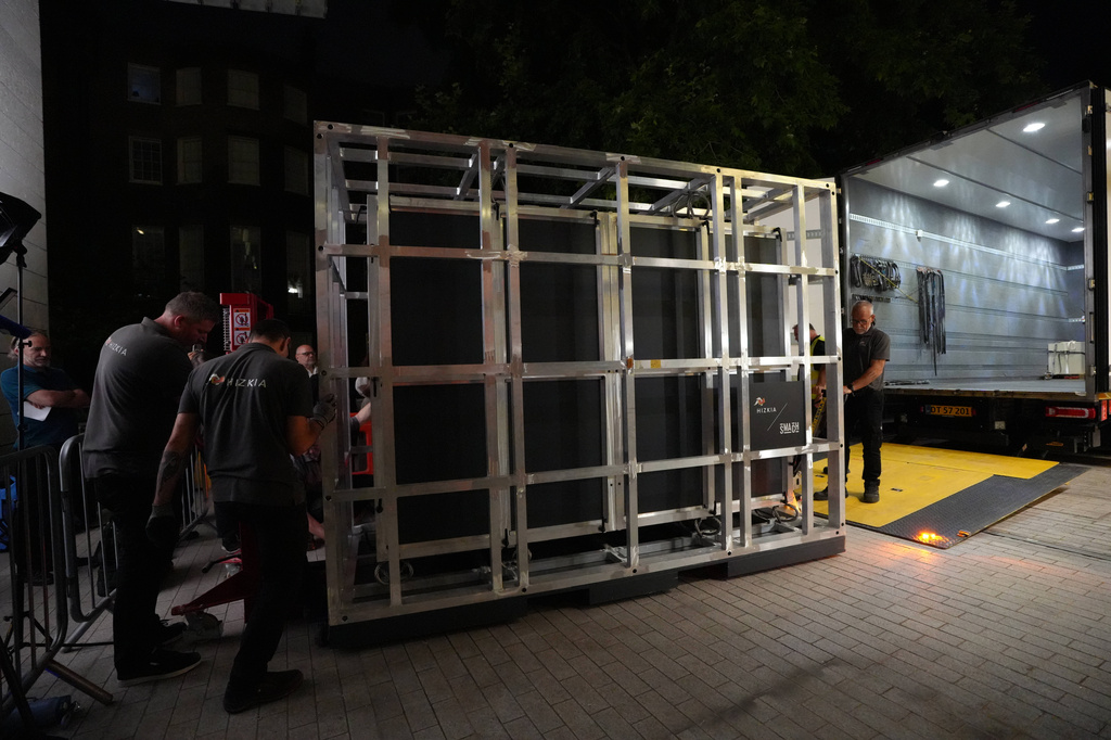 Workers unload a box that contains the Bayeux Tapestry from a truck at the British Museum in London, Friday, July 10, 2026. (AP Photo/Kwiyeon Ha)