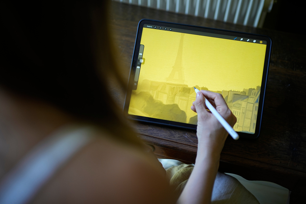 Illustrator Marina Antonova works on a drawing for her series called "Chronicles of a Heating Planet" in Beaumont-les-Valence, southern France, on Sept. 12, 2026. (AP Photo/Laurent Cipriani)