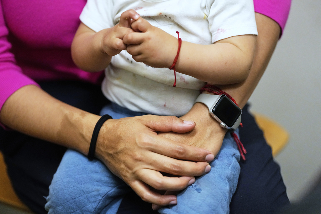FILE - A woman and her 16-month-old son wait to see a doctor at a CommuniCARE+OLE clinic in Davis, Calif., June 26, 2025. (AP Photo/Godofredo A. Vásquez, File)