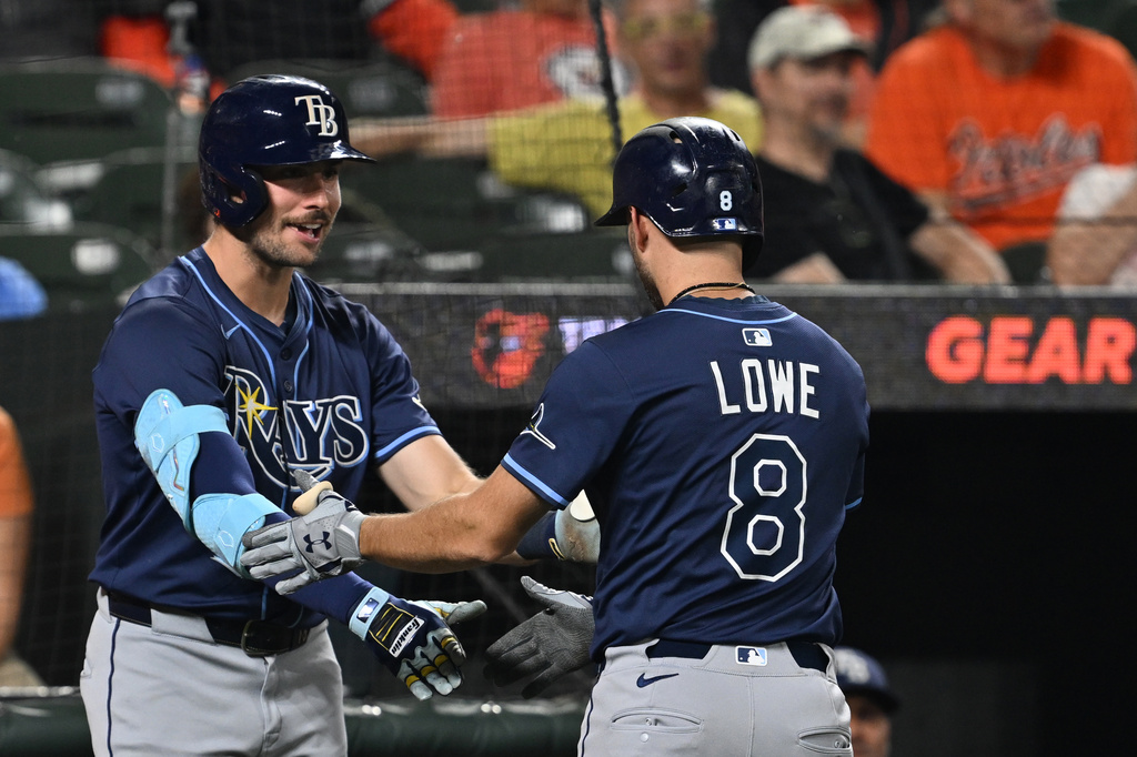 Tampa Bay Rays Brandon Lowe, right, is congratulated by Hunter Feduccia after hitting a solo home run against the Baltimore Orioles in the third inning of a baseball game, Wednesday, Sept. 24, 2025, in Baltimore. (AP Photo/Gail Burton)