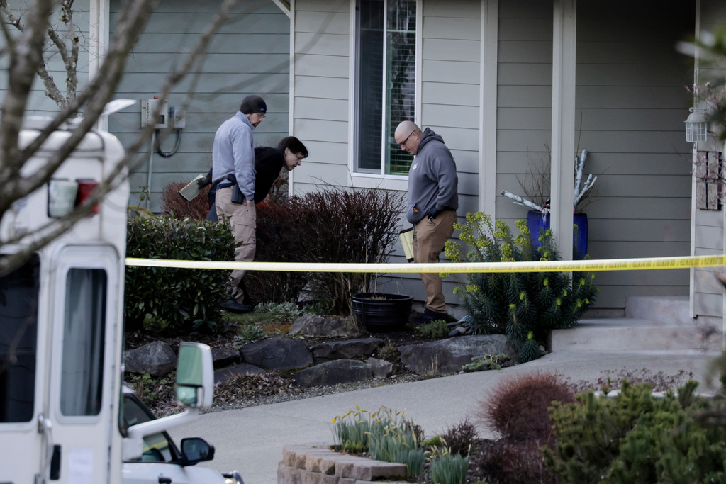 Authorities investigate the scene after reports that a man fatally stabbed multiple people, Tuesday, Feb. 24, 2026, in Gig Harbor, Wash. (AP Photo/John Froschauer)
