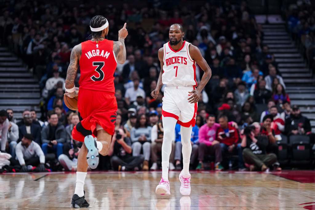 Toronto Raptors forward Brandon Ingram (3) plays the ball against Houston Rockets forward Kevin Durant (7) during the first half of preseason NBA basketball action in Toronto, Wednesday, Oct. 29, 2025. (Thomas Skrlj/The Canadian Press via AP)