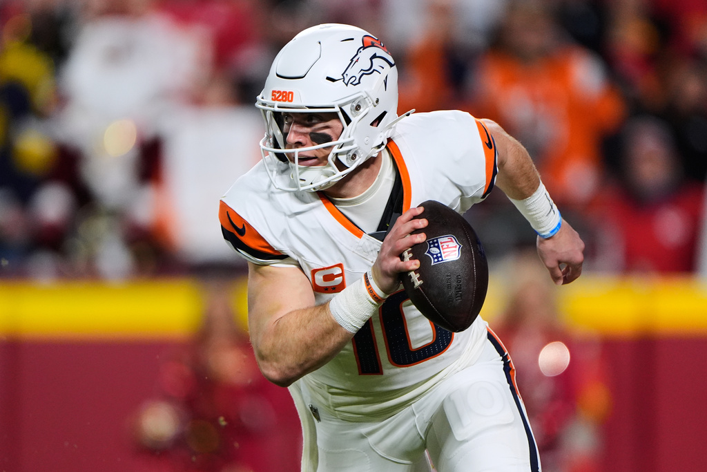 Denver Broncos quarterback Bo Nix runs the ball during the first half of an NFL football game against the Kansas City Chiefs, Thursday, Dec. 25, 2025, in Kansas City, Mo. (AP Photo/Charlie Riedel)