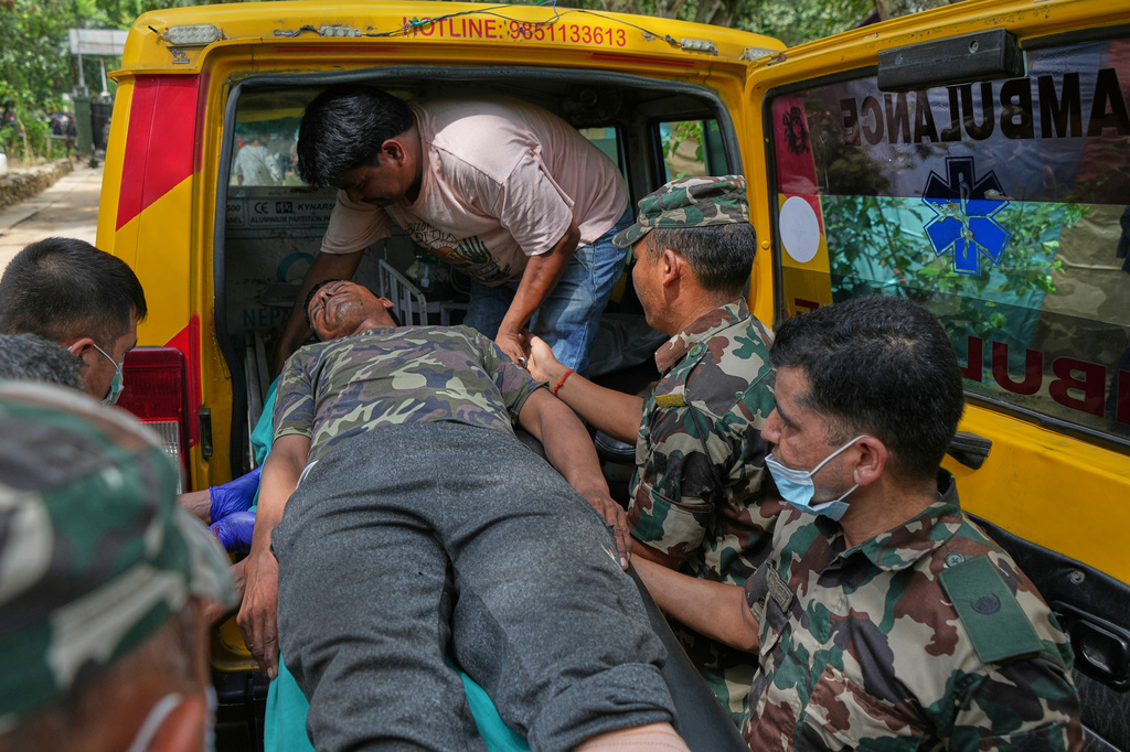 An injured rescued person from flash flooding is taken to a hospital in Nepal's Nuwakot district, Friday, Aug. 28, 2026. (AP Photo/Rajesh Kumar Singh)