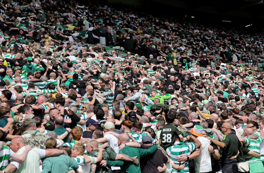 Celtic fans celebrate in the stands during the Scottish Premiership soccer match between Celtic and Rangers, in Glasgow, Sunday May 10, 2026. (Steve Welsh/PA via AP)