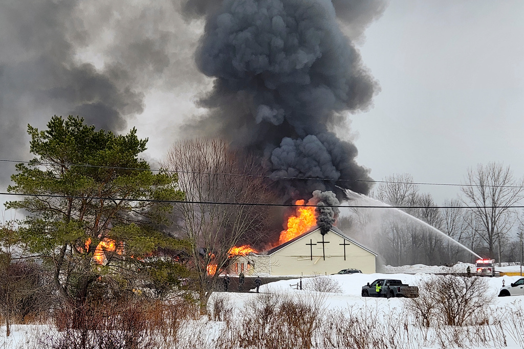 Firefighters battle a fire at the Abundant Life Fellowship Church, Tuesday, Feb. 17, 2026, in Boonville, N.Y. (Nichole Moore, Daily Sentinel/Boonville Herald via AP)