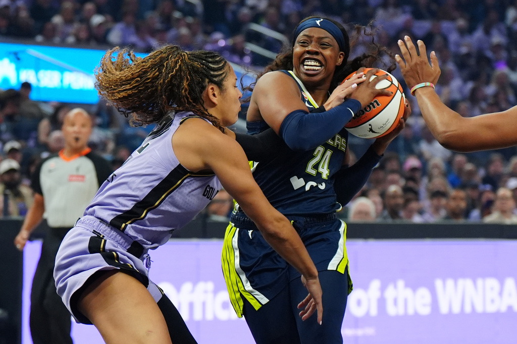Golden State Valkyries guard Veronica Burton, left, fouls Dallas Wings guard Arike Ogunbowale (24) during the first half of a WNBA basketball first-round playoff game Sunday, Sept. 27, 2026, in San Francisco. (AP Photo/Alan Greth)