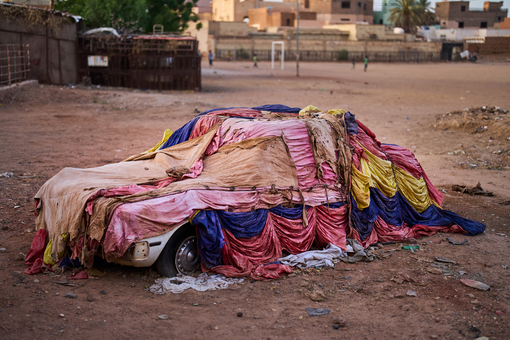 A car covered with cloths to protect it from the elements sits in a public park in Omdurman, on the outskirts of Khartoum, Sudan, Thursday, April 23, 2026. (AP Photo/Bernat Armangue)