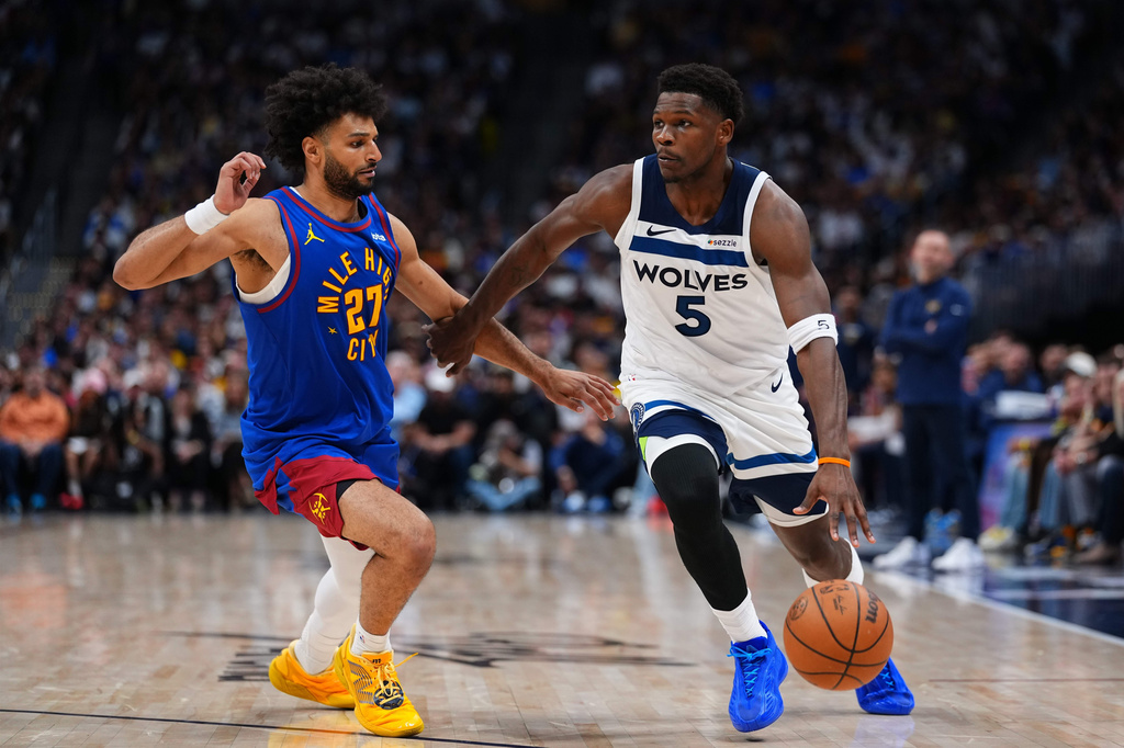 Minnesota Timberwolves guard Anthony Edwards (5) drives to the basket against Denver Nuggets guard Jamal Murray (27) during the second half in Game 2 of a first-round NBA playoffs basketball series Monday, April 20, 2026, in Denver. (AP Photo/Jack Dempsey)