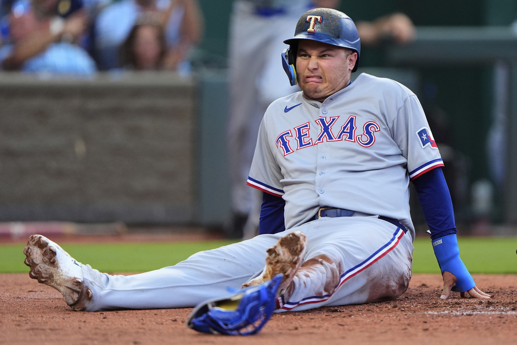 Texas Rangers' Joc Pederson reacts after getting the second out of a double play as he tried to score on fly out hit by Josh Smith during the second inning of a baseball game against the Kansas City Royals, Monday, Aug. 18, 2025, in Kansas City, Mo. (AP Photo/Charlie Riedel)