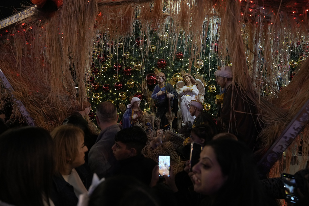 Palestinians take part in a Christmas tree–lighting event in Manger Square, next to the Church of the Nativity, traditionally regarded as the birthplace of Jesus Christ ahead of Christmas in the West Bank city of Bethlehem Saturday, Dec. 6, 2025. (AP Photo/Mahmoud Illean)