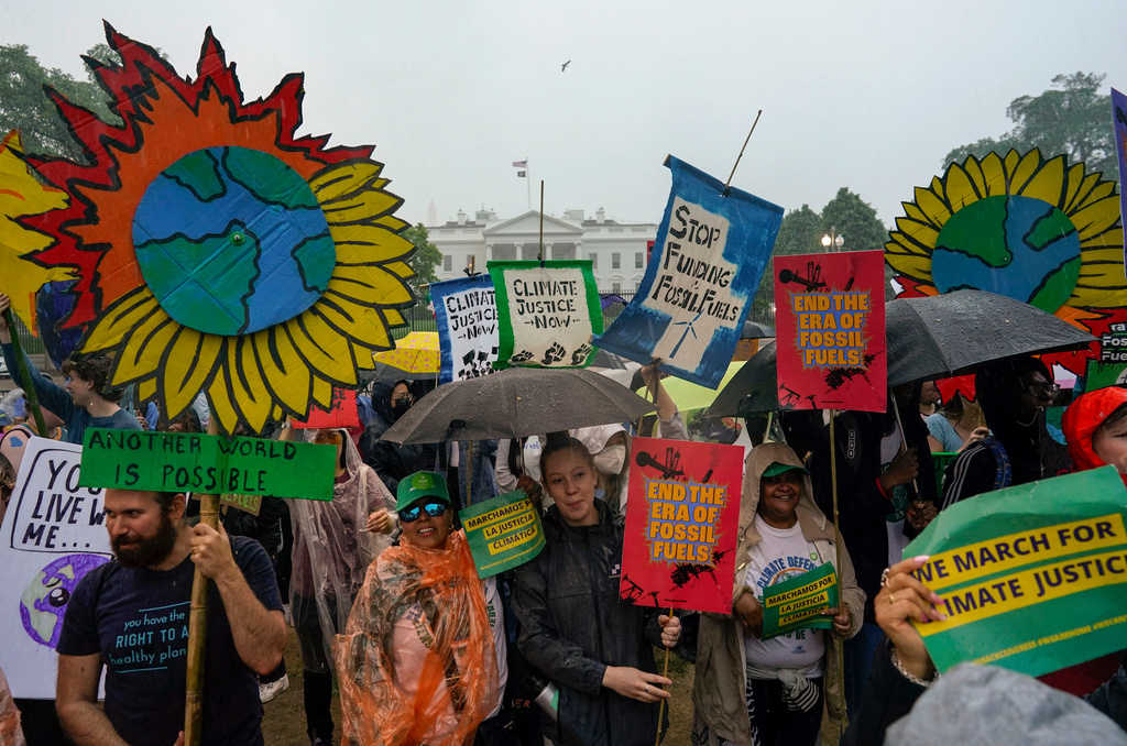 FILE - Climate activists hold a rally to protest the use of fossil fuels on Earth Day in the rain front of the White House on April 22, 2023, in Washington. (AP Photo/Carolyn Kaster, File)