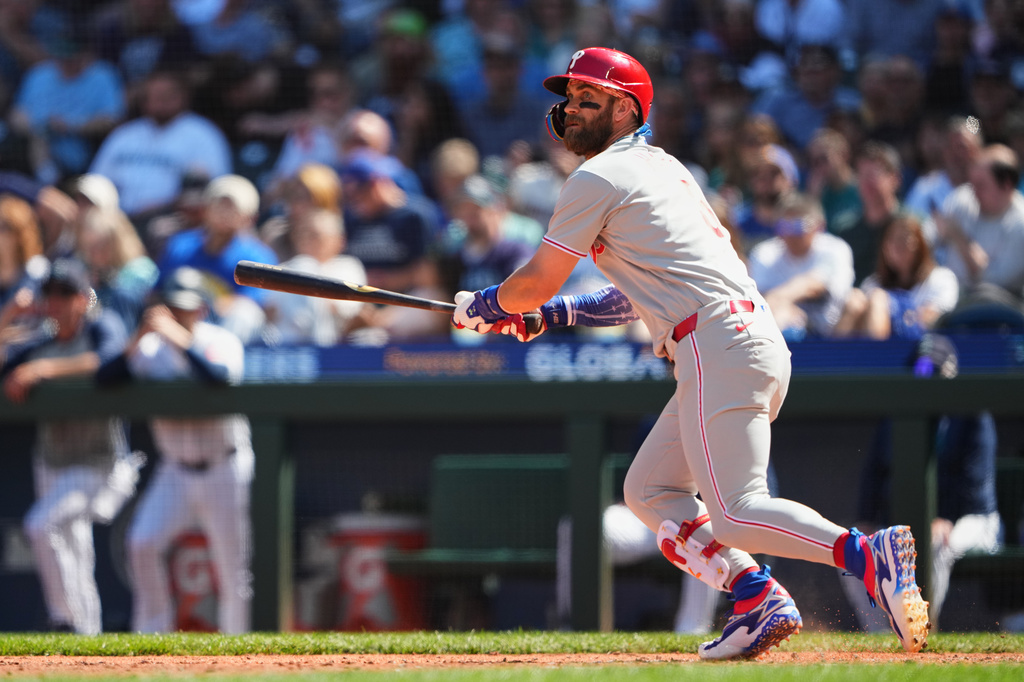 Philadelphia Phillies' Bryce Harper follows through on a double during the fifth inning of a baseball game against the Seattle Mariners, Wednesday, Aug. 26, 2026, in Seattle. (AP Photo/Lindsey Wasson)