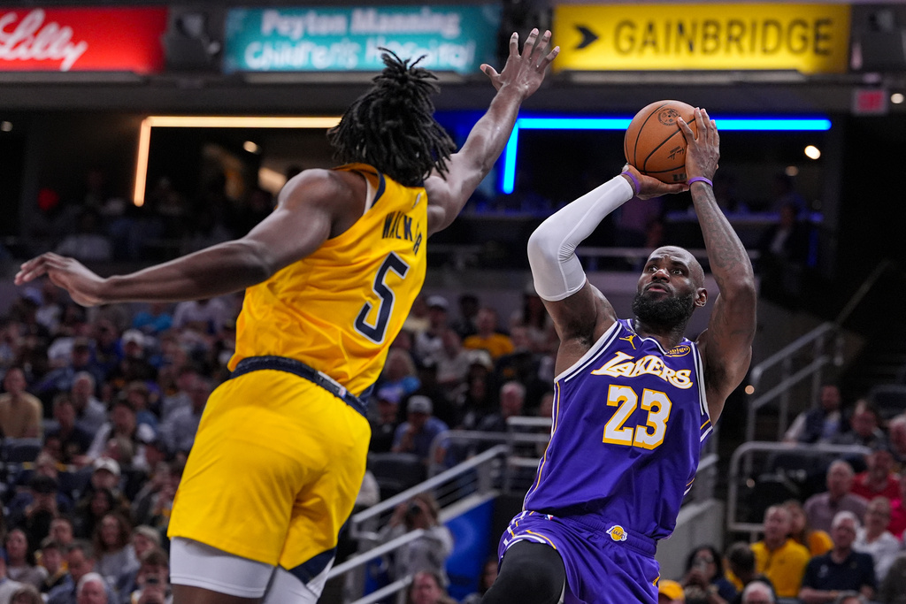 Los Angeles Lakers forward LeBron James (23) shoots over Indiana Pacers forward Jarace Walker (5) during the second half of an NBA basketball game in Indianapolis, Wednesday, March 25, 2026. (AP Photo/Michael Conroy)