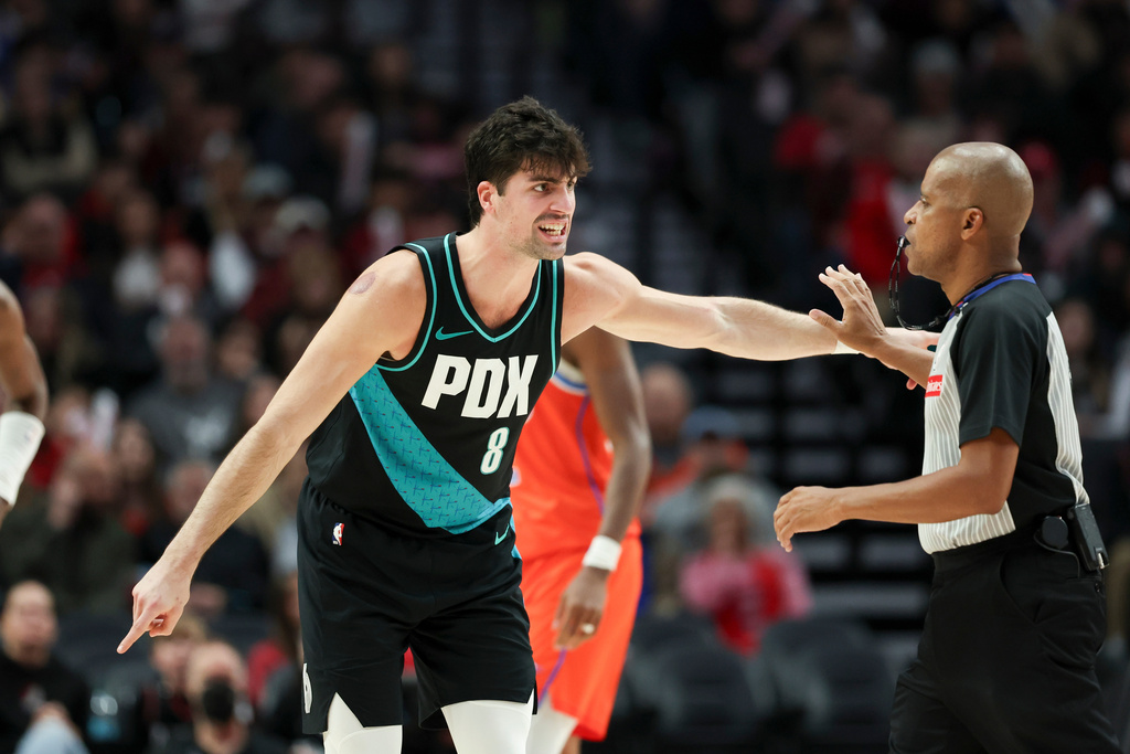 Portland Trail Blazers forward Deni Avdija (8) reacts to a call by referee Sean Corbin (33) during the second half of an NBA basketball game against the Oklahoma City Thunder, Sunday, Nov. 30, 2025, in Portland, Ore. (AP Photo/Amanda Loman)