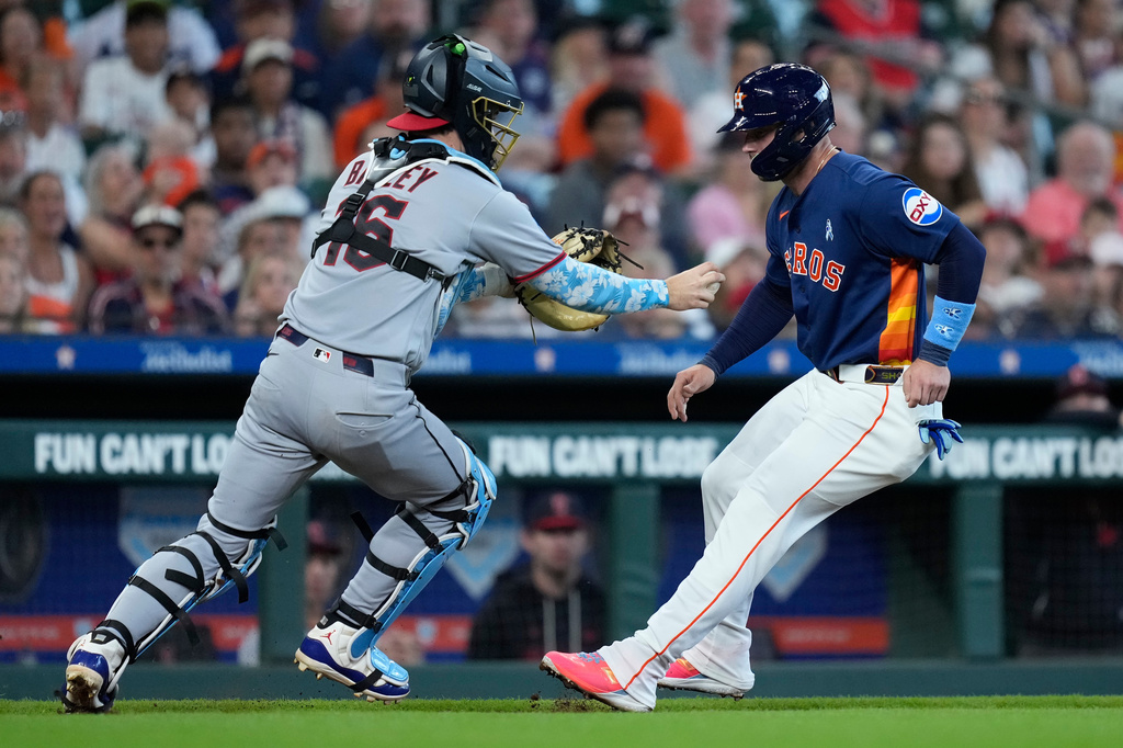 Cleveland Guardians catcher Patrick Bailey, left, catches Houston Astros' Christian Walker, right, in a rundown during the fourth inning of a baseball game Sunday, June 21, 2026, in Houston. (AP Photo/Kevin M. Cox)