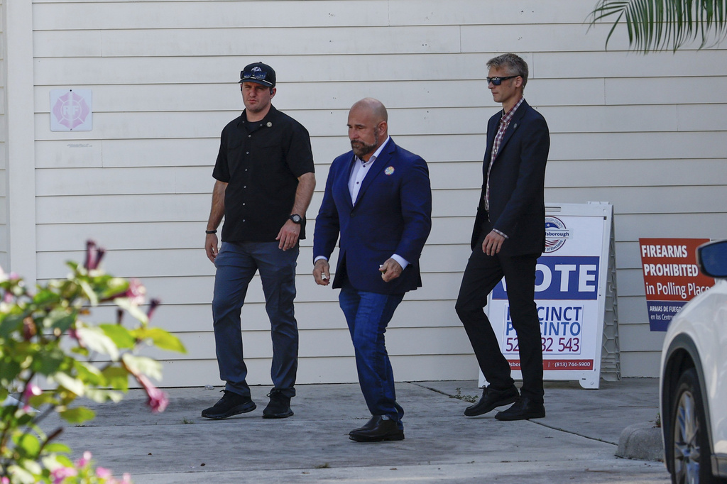 Florida Lt. Gov. and Republican gubernatorial candidate Jay Collins, center, walks after casting his ballot at Keystone Korean Baptist Church, Tuesday, Aug. 18, 2026, in Tampa. (Jefferee Woo/Tampa Bay Times via AP)