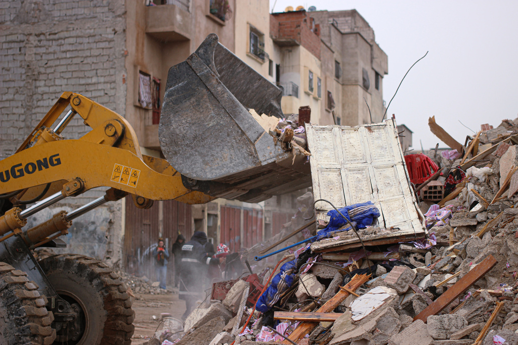Rescue workers search for survivors, amid the wreckage of two collapsed buildings, in Fez, Morocco, Wednesday, Dec. 10, 2025. (AP Photo/Hanane Boukili)