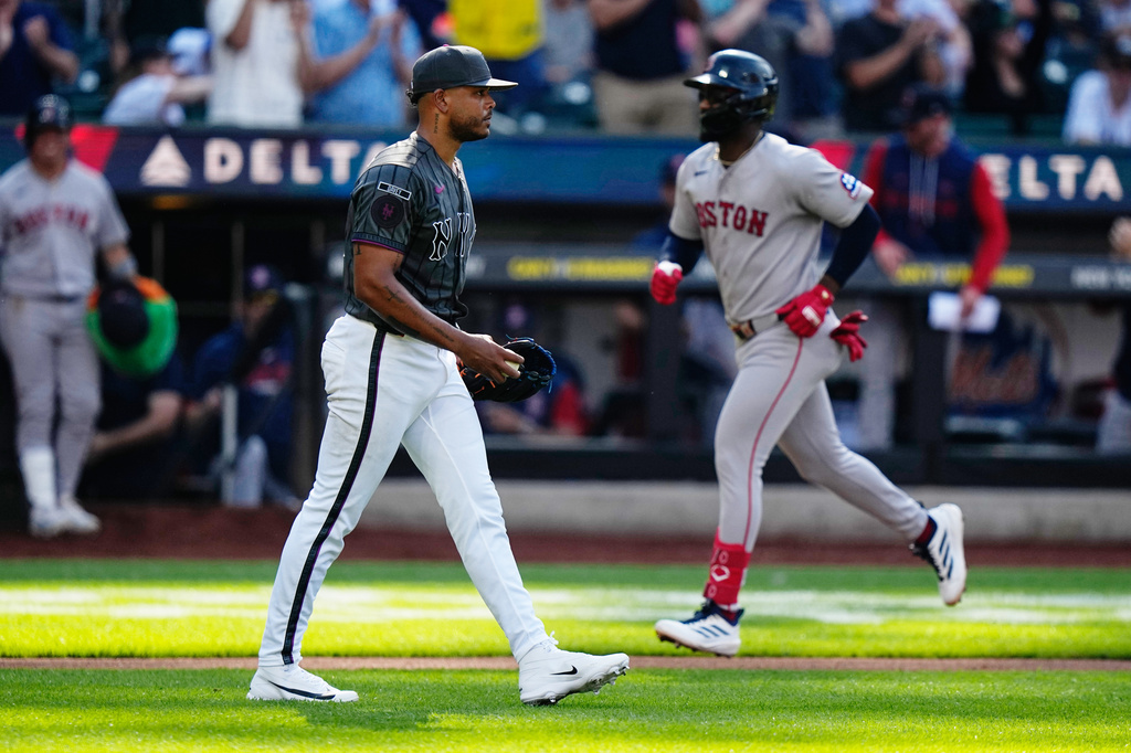 New York Mets pitcher Freddy Peralta, left, reacts as Boston Red Sox's Andruw Monasterio runs the bases after hitting a two-run home run during the fourth inning of a baseball game Saturday, July 11, 2026, in New York. (AP Photo/Frank Franklin II)