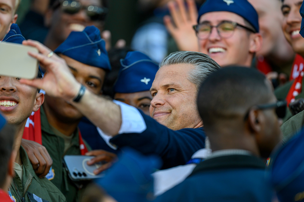 Secretary of War Pete Hegseth takes a selfie with Cadets as he attends an NCAA college football game between Navy and Air Force in Air Force Academy, Colo., Saturday, Oct. 3, 2026. (AP Photo/Tyler Tate)