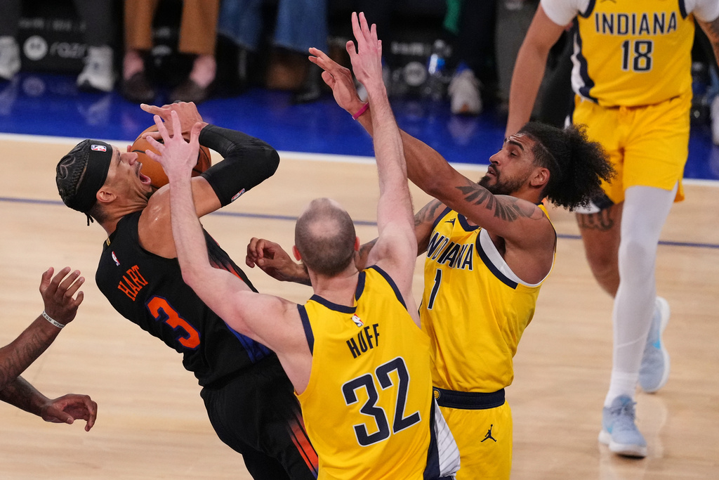 Indiana Pacers' Jay Huff (32) and Obi Toppin (1) defend a shot by New York Knicks' Josh Hart (3) during the second half of an NBA basketball game Tuesday, March 17, 2026, in New York. (AP Photo/Frank Franklin II)