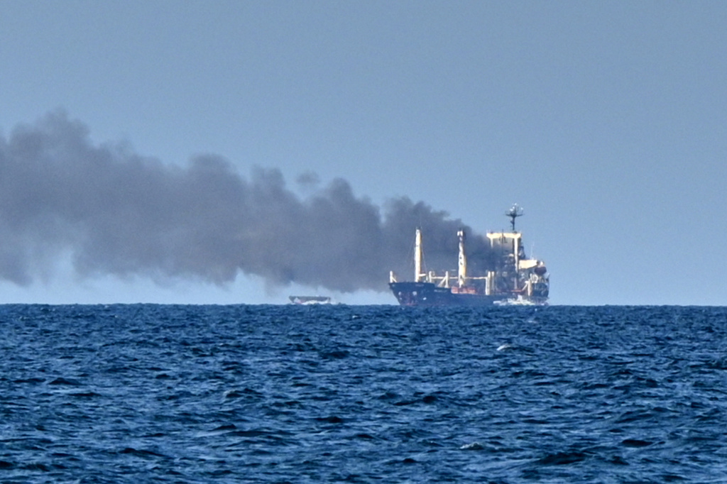 Smoke rises from the grain carrier Golden Leo under the Guinea-Bissau flag after Russian missile strike in the Black Sea close to Odesa, Ukraine, Sunday, July 19, 2026, local media reports. (AP Photo/Michael Shtekel)