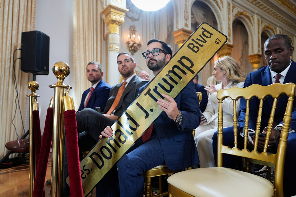 Attendees wait for President Donald Trump to arrive at a dedication ceremony for a portion of Southern Boulevard, which the Town of Palm Beach Council recently voted to rename,"President Donald J. Trump Boulevard," Friday, Jan. 16, 2026, at his Mar-a-Lago Club in Palm Beach, Fla. (AP Photo/Julia Demaree Nikhinson)