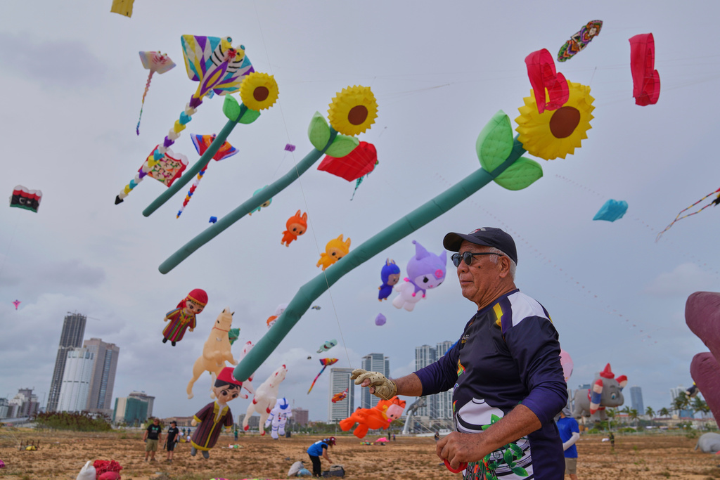 A participant flies his kite during the Colombo International Kite Festival in Colombo, Sri Lanka, Saturday, Aug. 23, 2025. (AP Photo/Eranga Jayawardena)
