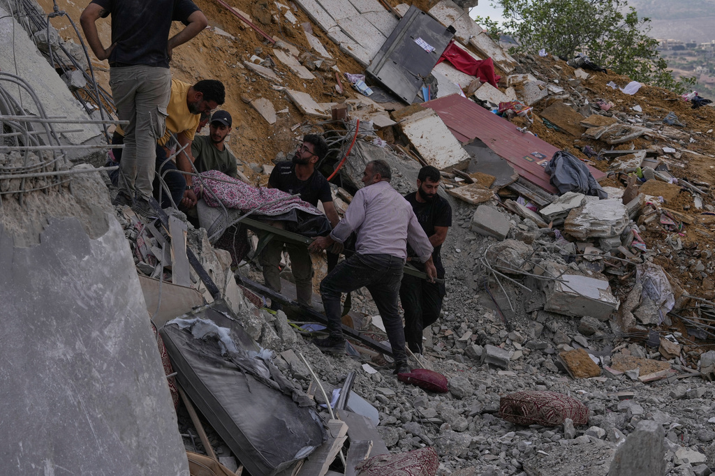 People carry a body of a person who was killed at a house that was hit by an Israeli airstrike in Arab Salim village, southern Lebanon, Sunday, Sept. 6, 2026. (AP Photo/Mohammed Zaatari)