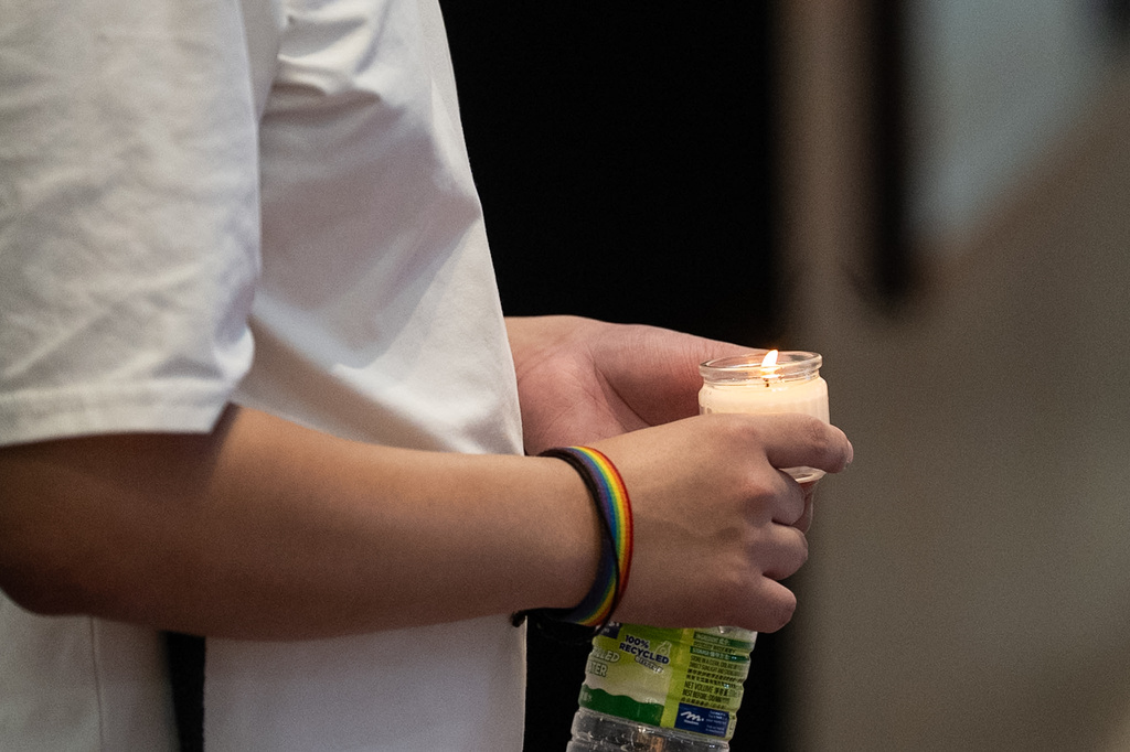 A man holds a candle on the street in the Causeway Bay area on the 37th anniversary of China's Tiananmen Square crackdown, in Hong Kong, Thursday, June 4, 2026. (AP Photo/Chan Long Hei)