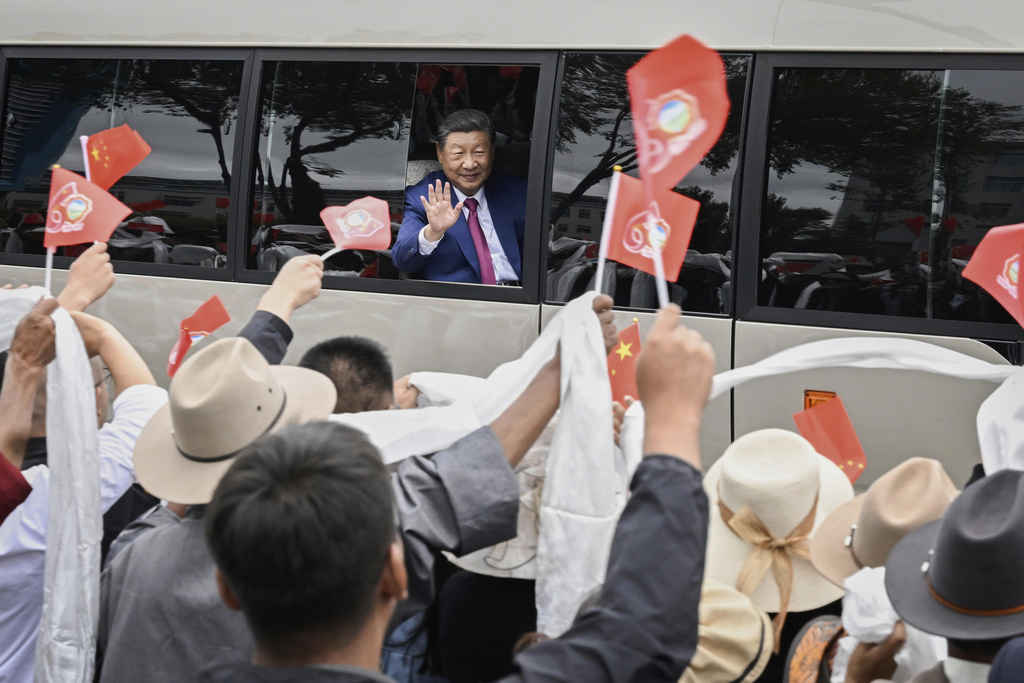 In this photo released by Xinhua News Agency, Chinese President Xi Jinping waves to people from a vehicle as he arrives at Lhasa in western China's Tibet Autonomous Region on Wednesday, Aug. 20, 2025, to attend an event to mark the 60th anniversary of the consolidation of Beijing's long-contested rule over the Himalayan territory. (Shen Hong/Xinhua via AP)