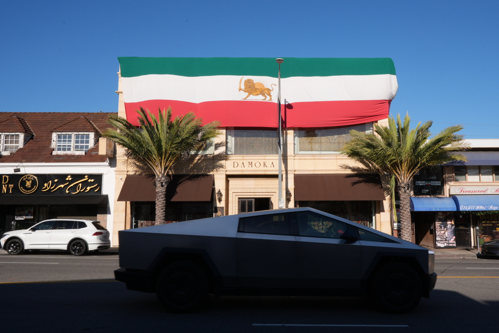A giant The Lion and Sun flag, the pre-revolution Iranian national flag, decorates the exterior of Damoka rug store along Westwood Boulevard, in the Westwood neighborhood of Los Angeles, at the heart of the largest Iranian diaspora community in the United States, Monday, March 2, 2026. (AP Photo/Damian Dovarganes)