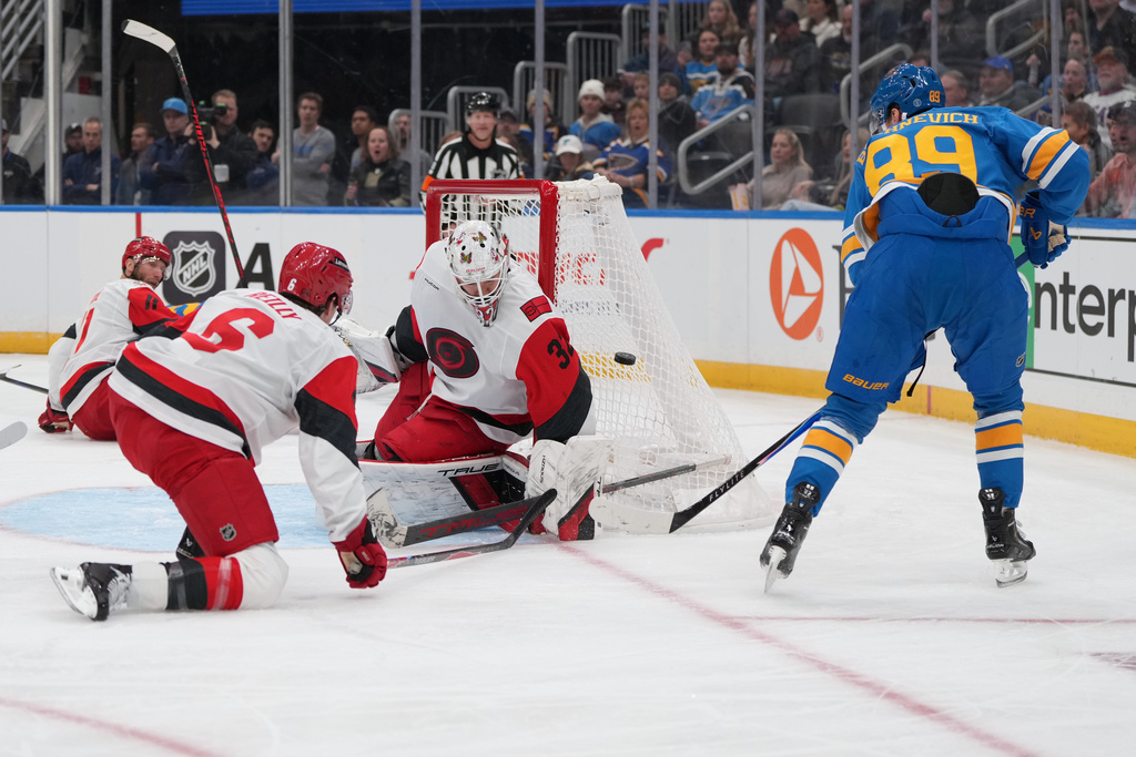 St. Louis Blues' Pavel Buchnevich (89) is unable to score past Carolina Hurricanes goaltender Brandon Bussi (32) and defenseman Mike Reilly (6) during the second period of an NHL hockey game Tuesday, Jan. 13, 2026, in St. Louis. (AP Photo/Jeff Roberson)