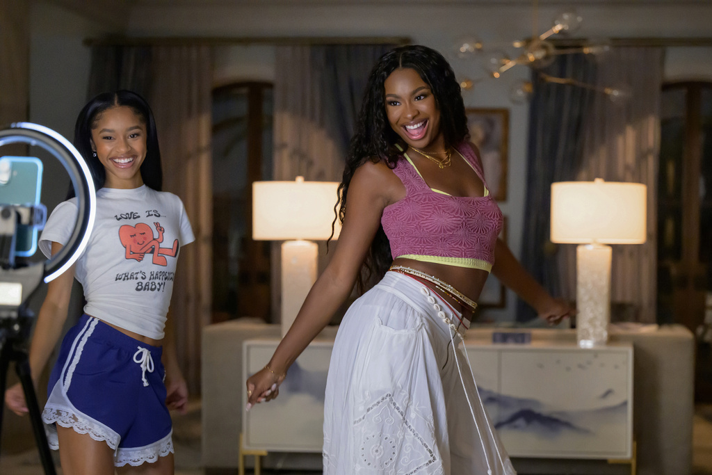 This image released by Peacock shows Akira Akbar as Ashley, left, and Coco Jones as Hilary, in a scene from Bel-Air." (Anne Marie Fox/Peacock via AP)