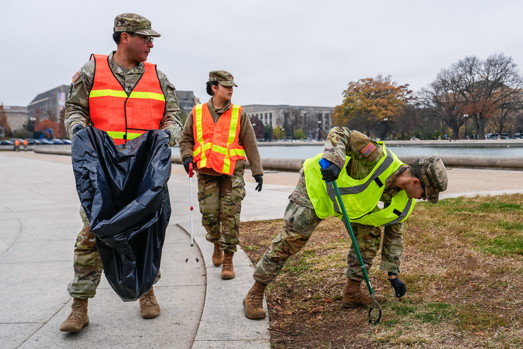 Members of the District of Columbia National Guard pick up trash by the Capitol reflecting pool, Friday, Nov. 21, 2025, in Washington. (AP Photo/Julia Demaree Nikhinson)