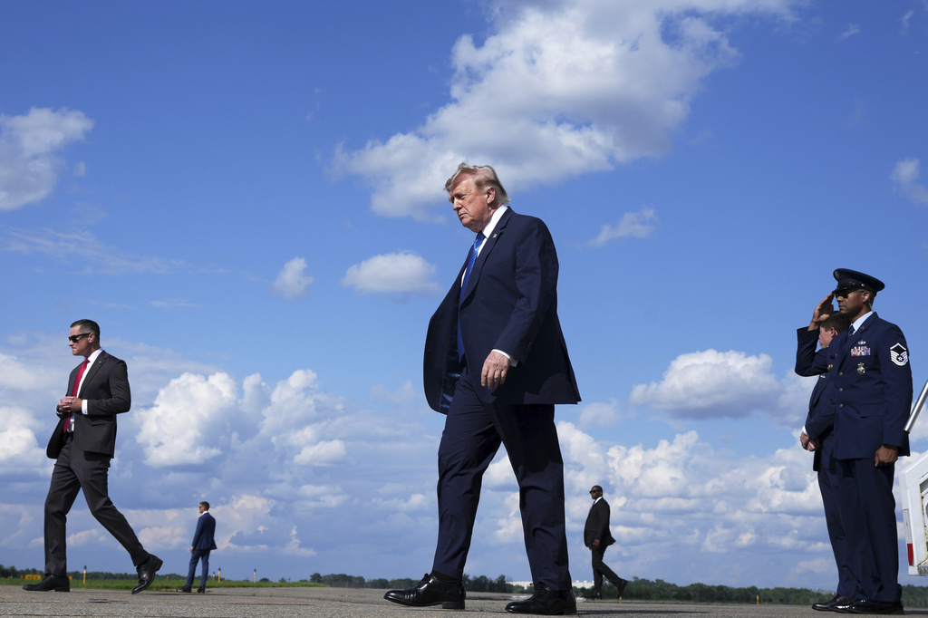 President Donald Trump, center, walks from Air Force One at Morristown Municipal Airport in Morristown, N.J., Friday, July 31, 2026, from Camp David, the presidential retreat. (AP Photo/Jacquelyn Martin)