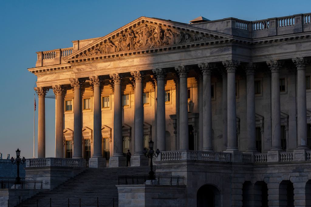 FILE - The House of Representatives at the Capitol is illuminated at dawn in Washington, Oct. 6, 2025. (AP Photo/J. Scott Applewhite, File)