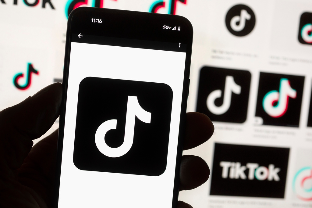 FILE - The TikTok logo is displayed on a mobile phone in front of a computer screen, Oct. 14, 2022, in Boston. (AP Photo/Michael Dwyer, File)