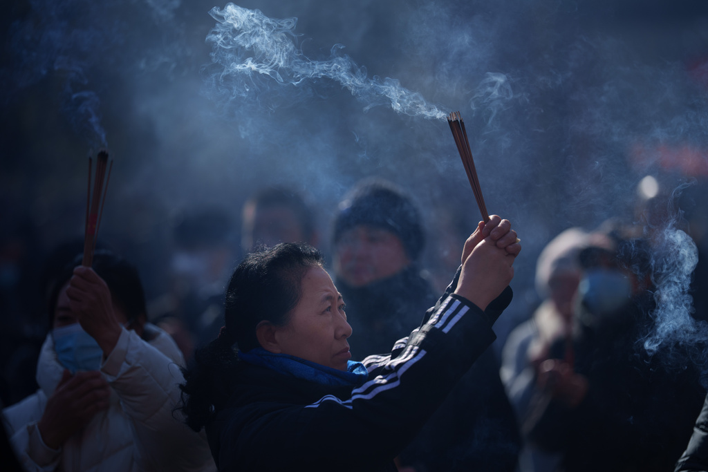 Visitors light incense and pray during the first day of Lunar New Year at Lama Temple in Beijing, China, Tuesday, Feb. 17, 2026. (AP Photo/Vincent Thian)