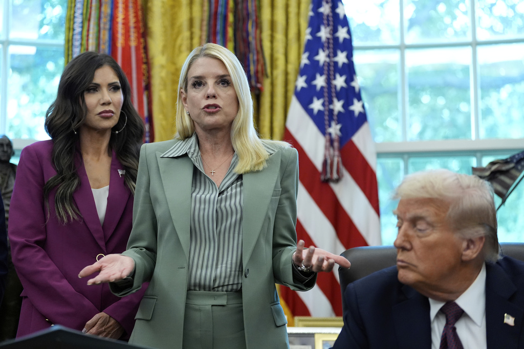 Attorney General Pam Bondi speaks as Homeland Security Secretary Kristi Noem, left, and President Donald Trump listen in the Oval Office of the White House, Monday, Sept. 15, 2025, in Washington. (AP Photo/Alex Brandon)