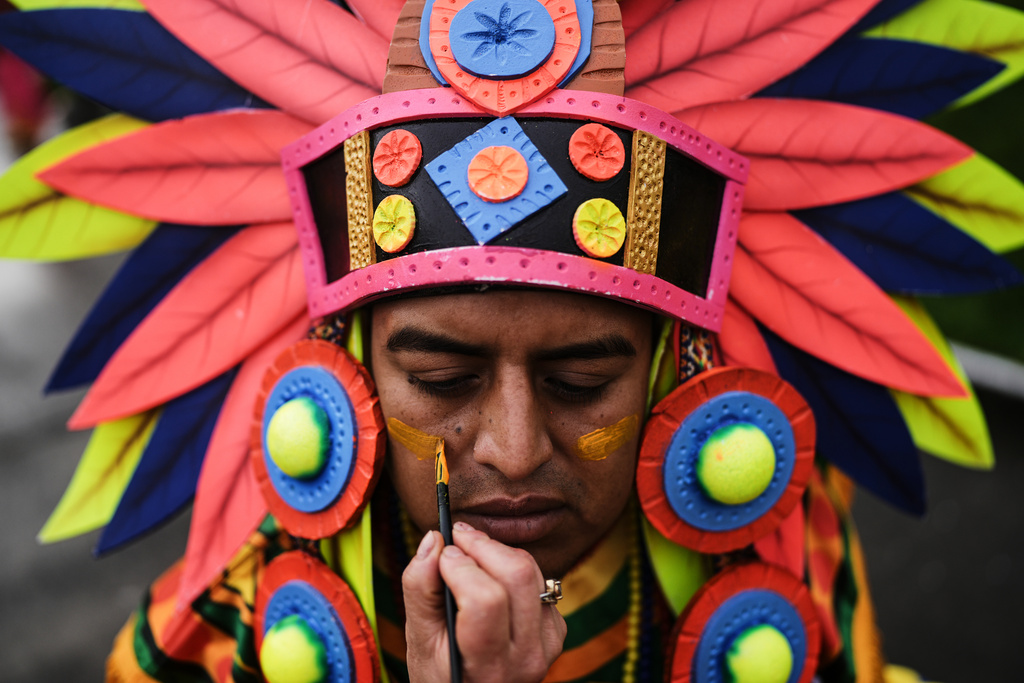 A reveler prepares for the Black and White Carnival, recognized by UNESCO as Intangible Cultural Heritage, in Pasto, Colombia, Tuesday, Jan. 6, 2026. (AP Photo/Ivan Valencia)