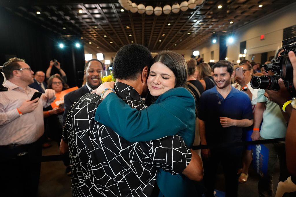 Rep. Haley Stevens, D-Mich., a candidate in the Democratic primary for U.S. Senate in Michigan, right, hugs an attendee during a primary election night event Wednesday, Aug. 5, 2026, in Detroit. (AP Photo/Paul Sancya)